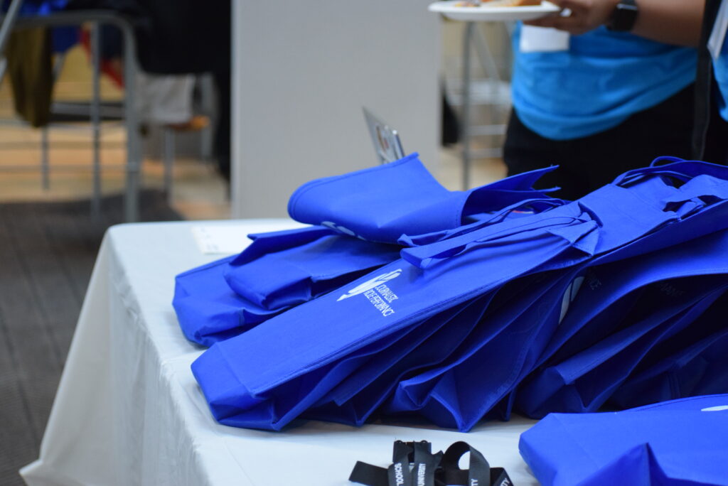 A side view of a blue JRP Canada bags lined up on a table.