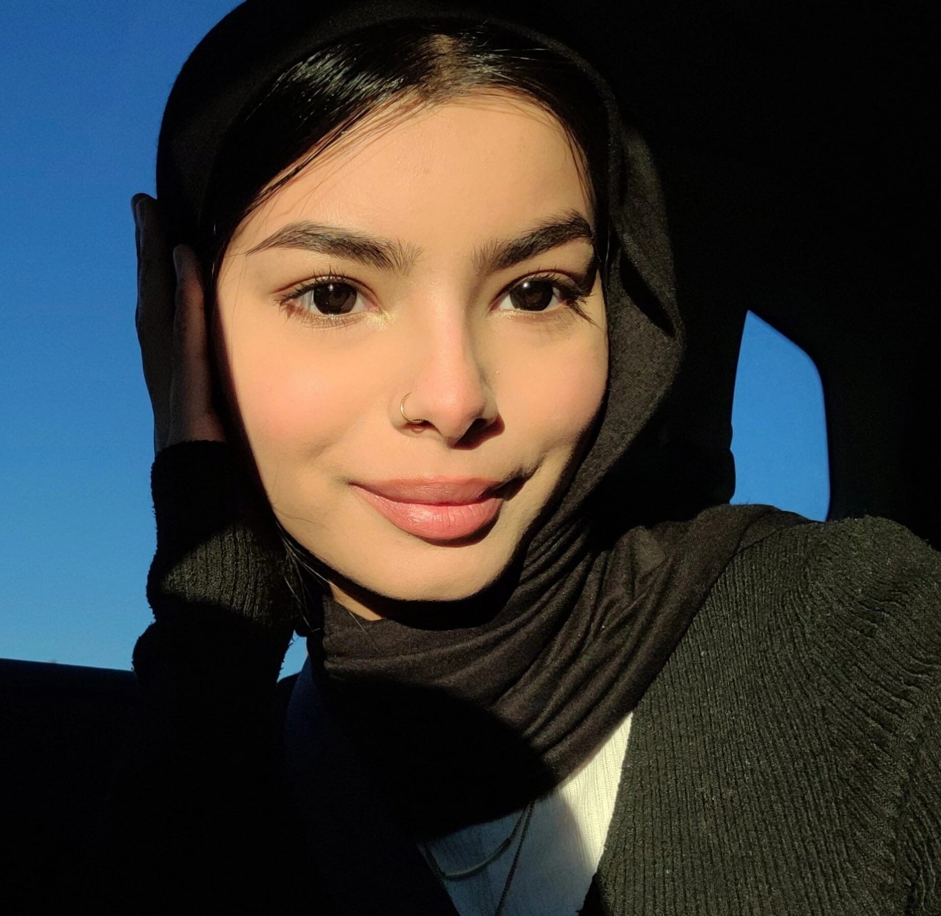 A photo of a woman wearing a black sweater